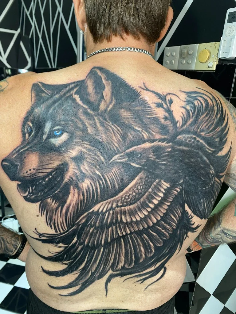 Black and Grey Wolf Raven Back Piece — Realism tattoo at Bali Family Tattoo Studio, Bali