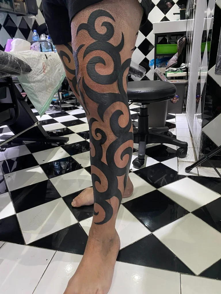Bold Tribal Leg Piece Tattoo — Tribal tattoo at Bali Family Tattoo Studio, Bali