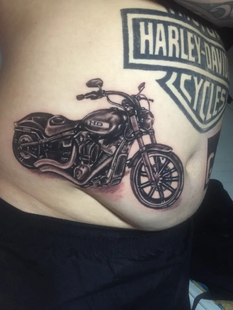 Realism Harley Davidson Motorcycle Rib Tattoo — Realism tattoo at Bali Family Tattoo Studio, Bali